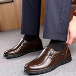 Brown slip-on shoes with stitched upper and dark rubber non-slip outsole
