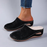 Black suede-look orthopedic slip-on slippers with stitched trim and cushioned insole.