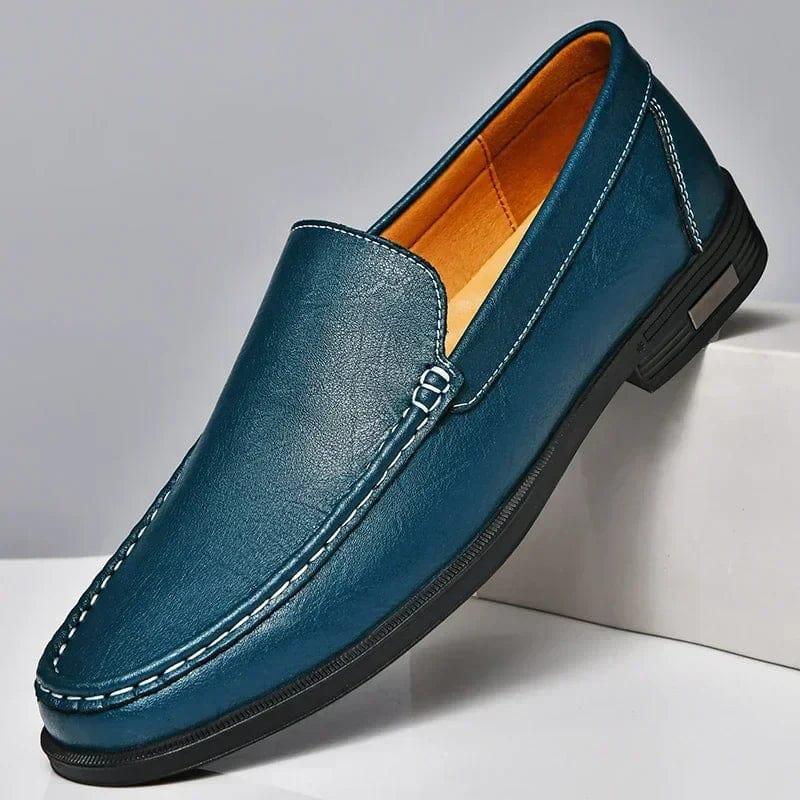 Men's blue leather penny loafer with metal buckle, slip-on design