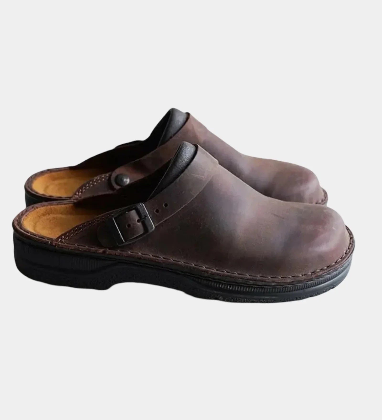 Dark brown leather-look clog with adjustable buckle strap and black sole.