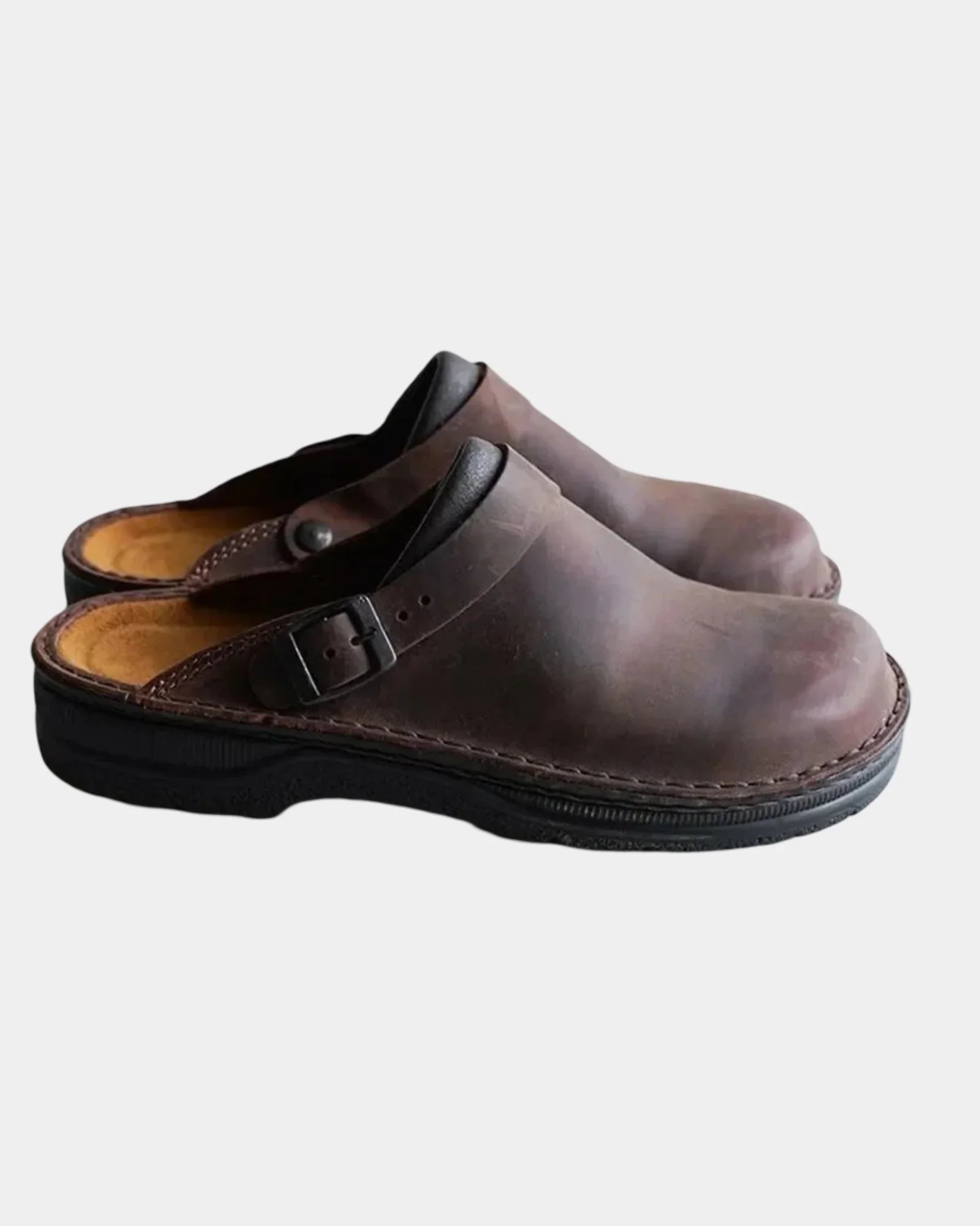 Dark brown leather-look clog with adjustable buckle strap and black sole.