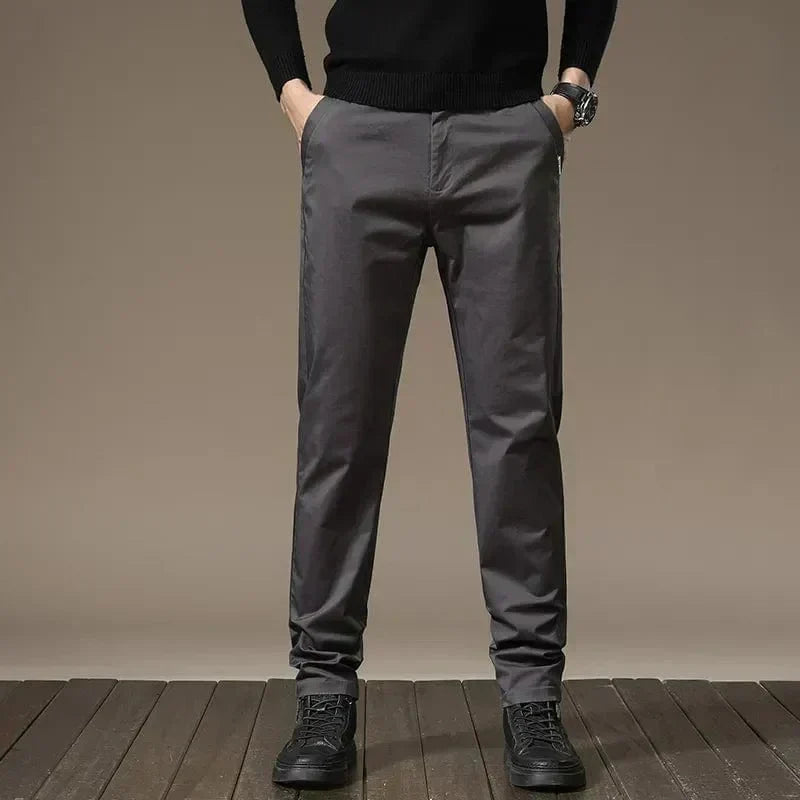 Charcoal gray slim chino pants with belt loops, button closure, straight tapered legs