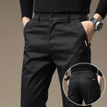 Charcoal gray slim chino pants with button fly, tapered legs, side and back pockets
