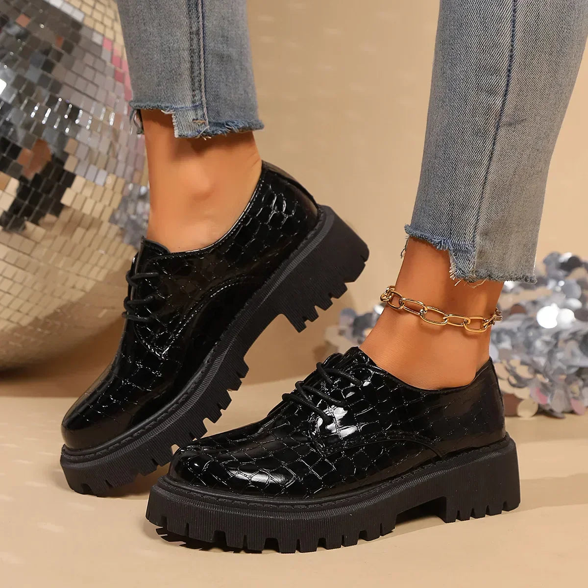 Black glossy patent leather lace-up derby shoes with thick tread sole