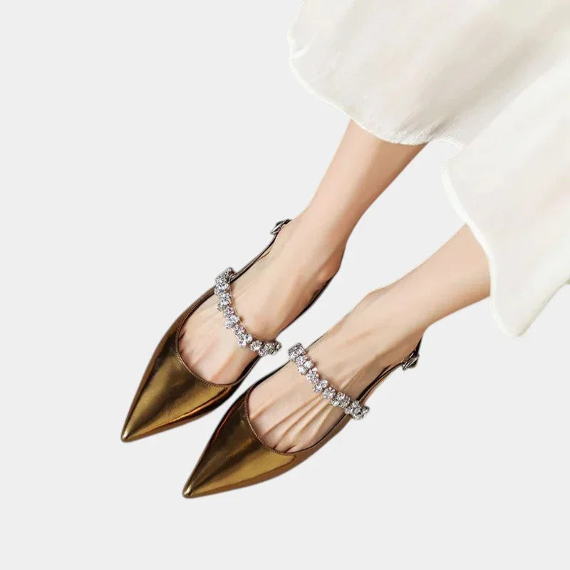 Gold pointed-toe slingback heels with rhinestone strap across the top