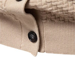 Beige knitted vest close-up of black button and ribbed cuff edge