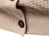 Beige knitted vest close-up of black button and ribbed cuff edge