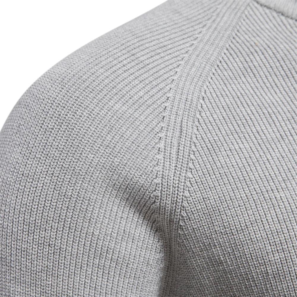 Close-up of textured knit fabric on a men's quarter-zip pullover shoulder area