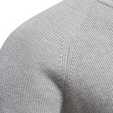 Close-up of textured knit fabric on a men's quarter-zip pullover shoulder area
