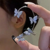 Silver butterfly ear cuff on ear, four crystal butterflies on open band