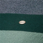 Brand logo patch on green band of a knit crewneck sweater