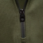 Men's olive green quarter-zip sweater zipper and placket close-up.