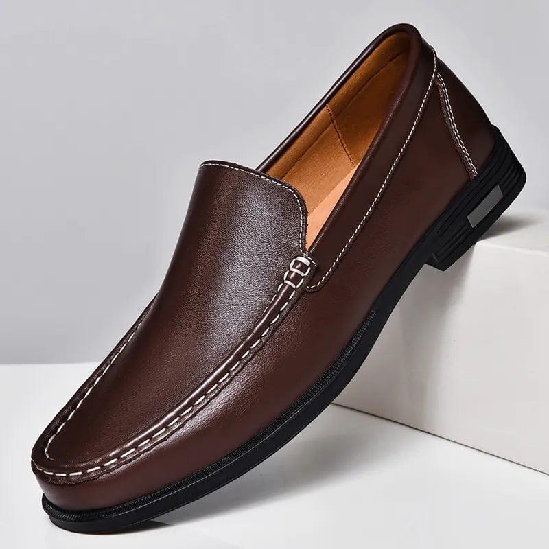 Brown leather loafer slip-on with decorative metal buckle strap and low block heel