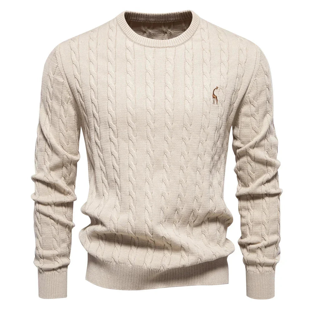 Men's light tan cable-knit crewneck sweater with long sleeves and small chest logo