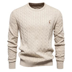 Men's light tan cable-knit crewneck sweater with long sleeves and small chest logo