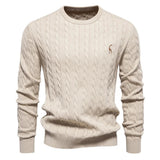 Men's light tan cable-knit crewneck sweater with long sleeves and small chest logo