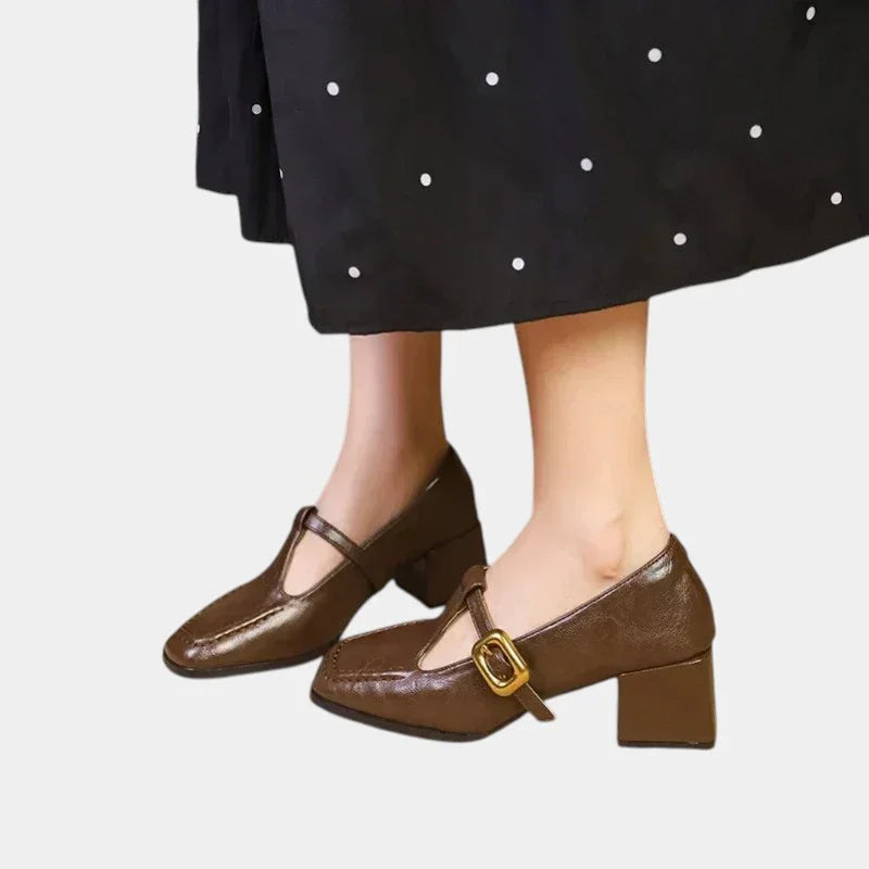 Women's heeled loafer-style shoe in brown with gold buckle strap