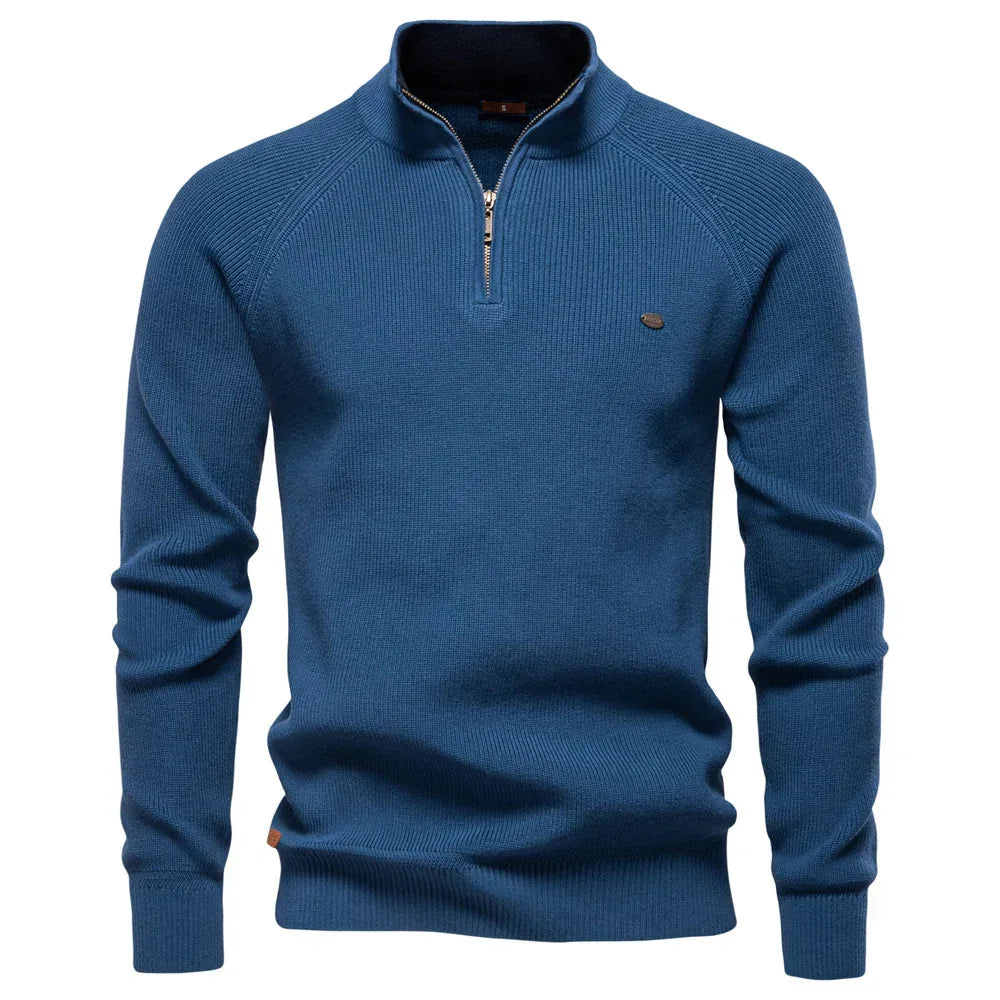 Men's denim blue quarter-zip knit pullover with long sleeves, ribbed cuffs, and hem