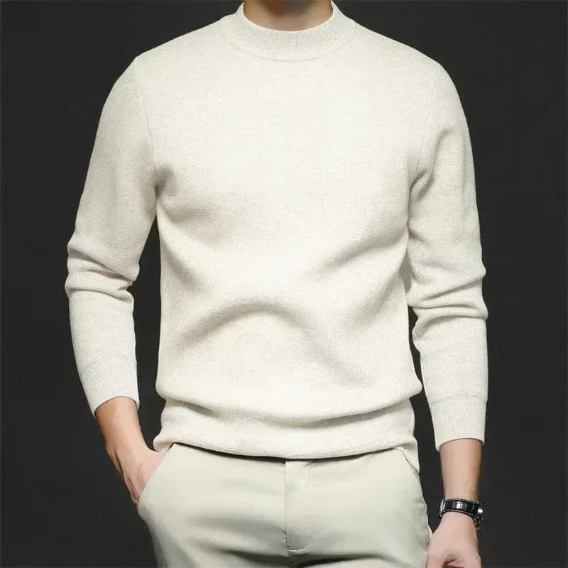 Cream high-neck knit sweater with long sleeves and ribbed cuffs.