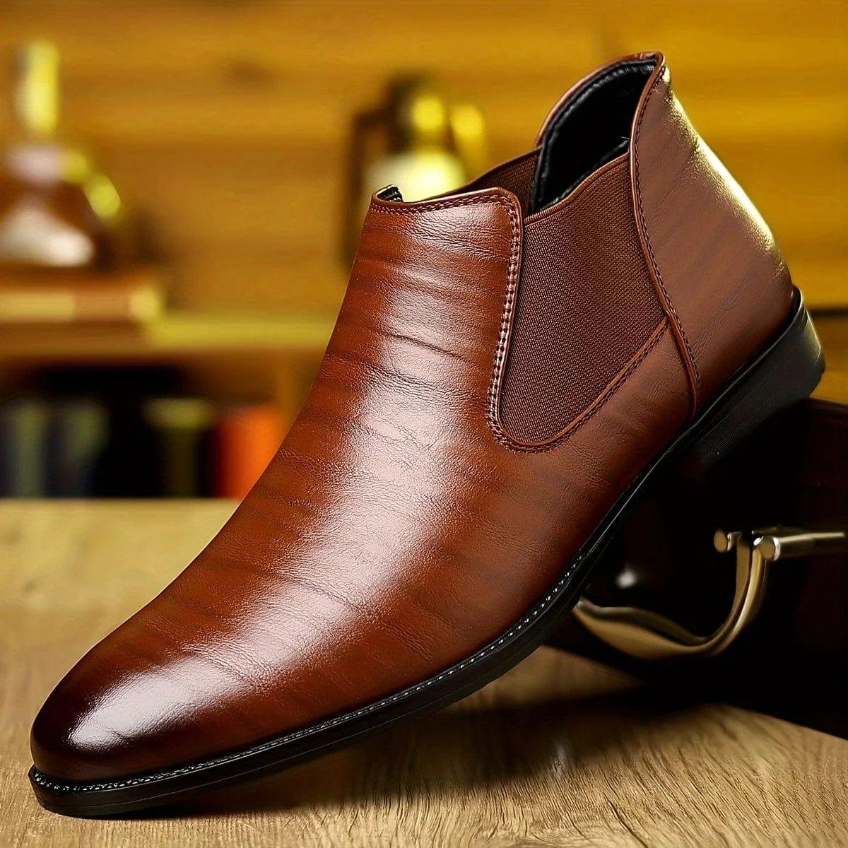 Brown leather Chelsea-style ankle boots with elastic side gore and smooth finish.