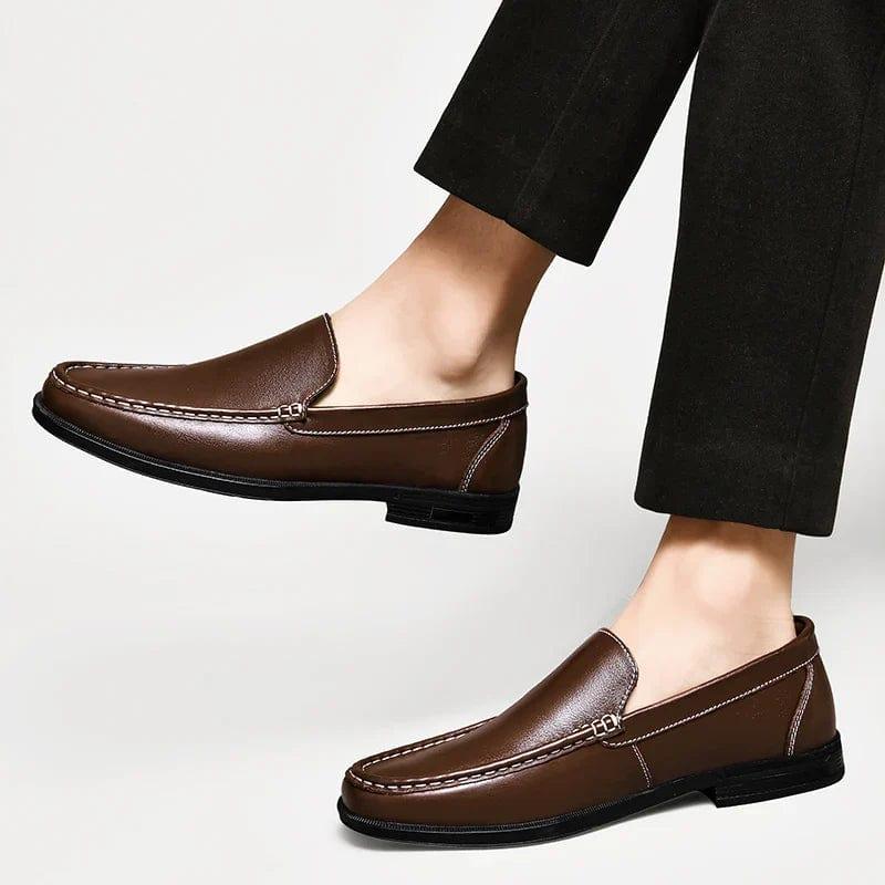 Brown leather loafers with stitched moc-toe and metal strap detail