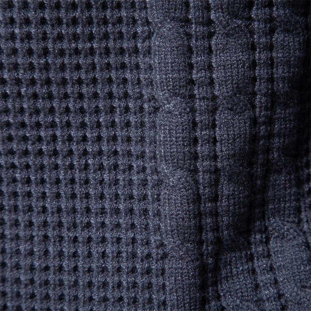 Close-up of dark blue knit sweater fabric with dotted pattern and vertical rib lines