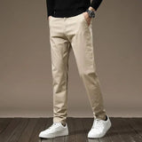 Sand color slim chino pants with button closure, belt loops, tapered legs