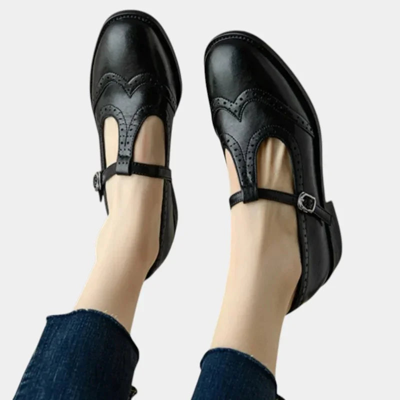 Women's black T-band dress shoes with brogue detailing and buckle ankle strap