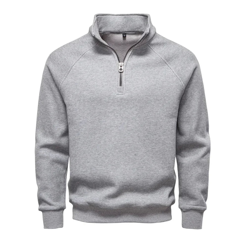 Men's light gray quarter-zip sweater with stand collar and ribbed cuffs and hem.