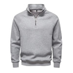 Men's light gray quarter-zip sweater with stand collar and ribbed cuffs and hem.