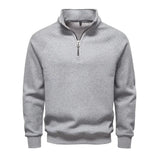 Men's light gray quarter-zip sweater with stand collar and ribbed cuffs and hem.