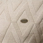 Cream knit sweater close-up with diamond texture and small logo patch