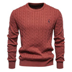 Men's red cable-knit crewneck sweater with long sleeves and small chest logo