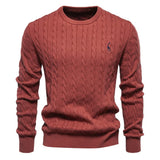 Men's red cable-knit crewneck sweater with long sleeves and small chest logo