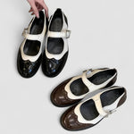 Two-tone classic buckle shoes, showing black and brown pairs with cream panels.