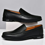 Pair of black leather loafers slip-on with moc toe stitching and low block heel