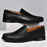 Pair of black leather loafers slip-on with moc toe stitching and low block heel