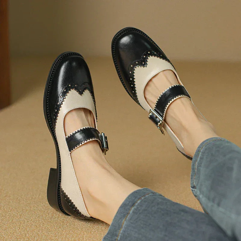 Two-tone leather Mary Jane shoes with buckle strap and wingtip trim