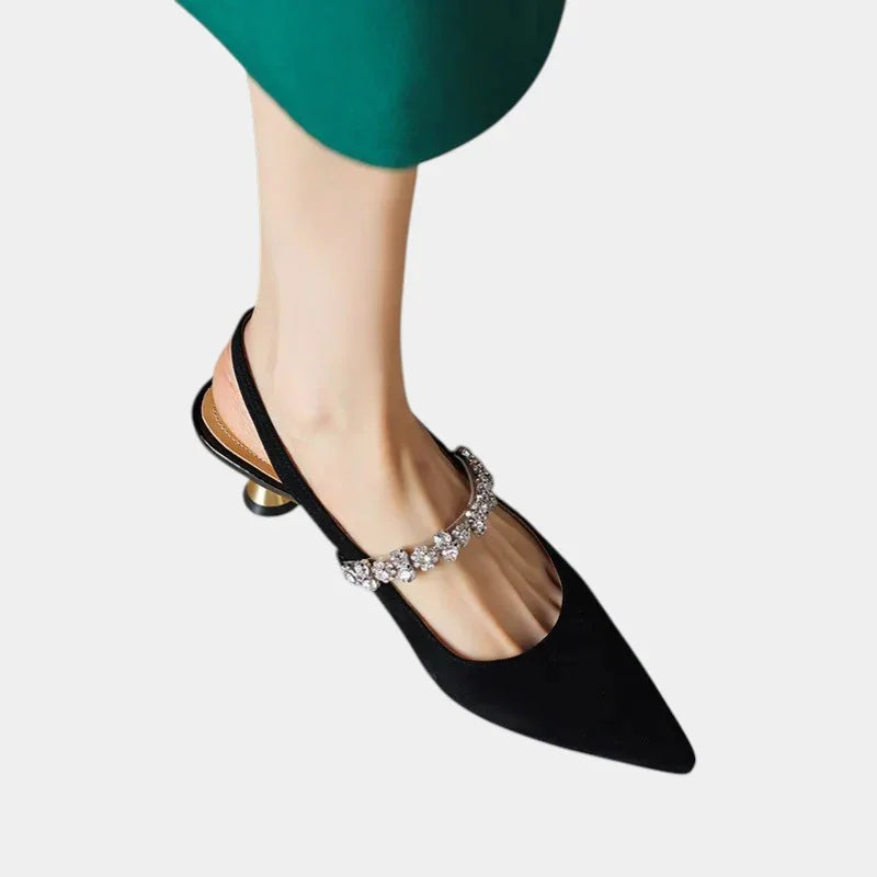 Black pointed-toe slingback heels with rhinestone strap and small block heel