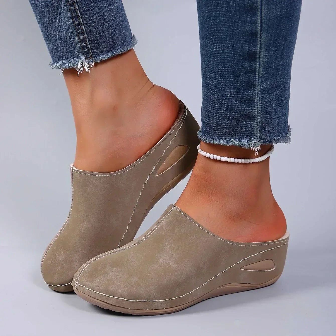 Brown suede-look slip-on slippers with cushioned insole and stitched side panels.