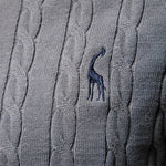 Gray sweater close-up with blue horse logo on cable knit