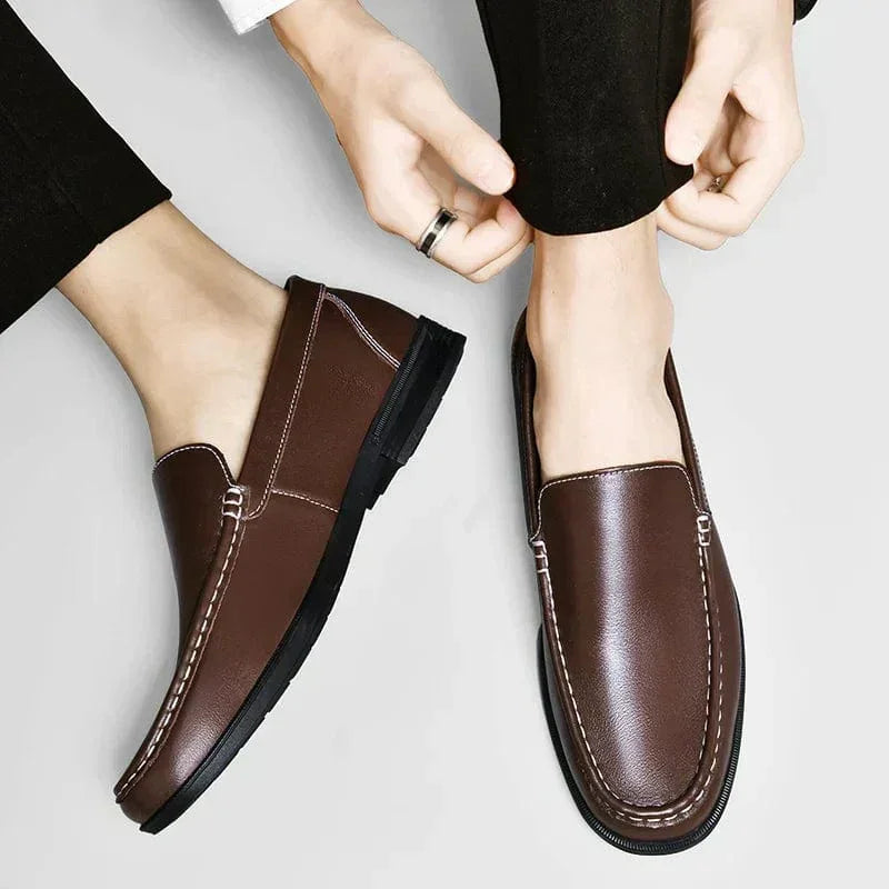 Brown leather slip-on loafers with stitched seams and dark rubber sole