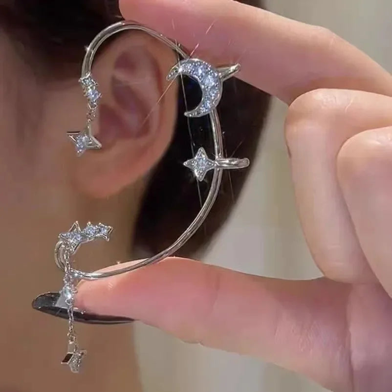 Silver lunar ear cuff featuring crescent moon and star dangles on ear