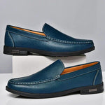 Pair of men's blue leather loafers with metal buckle strap and dark rubber sole