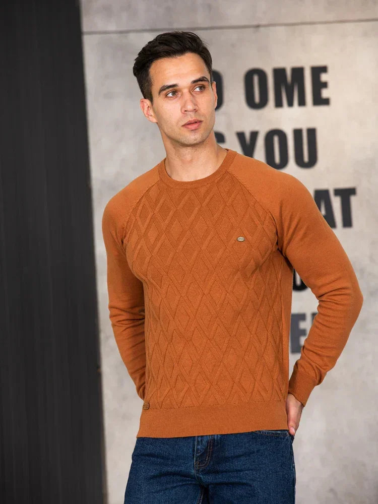 Men's rust brown sweater with diamond knit pattern worn with dark jeans