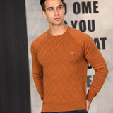 Men's rust brown sweater with diamond knit pattern worn with dark jeans