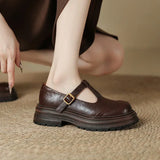 Brown Mary Jane leather shoe on foot, T-strap with gold-tone buckle