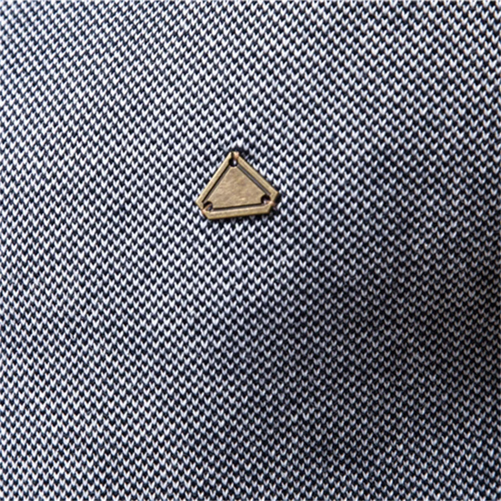 Gold triangular logo on textured knit sweater fabric