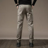 Beige-gray slim chino pants with button closure, belt loops, tapered trouser silhouette