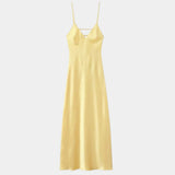 Yellow satin slip dress with V neckline, spaghetti straps, and straight floor-length cut
